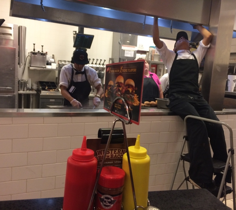 Steak N Shake - Oakwood, GA. Changing vent filters? Ass on counter? Unsanitary/. gross.... Particles falling in food