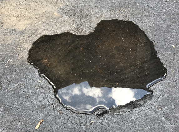 J R Paving Co Inc - Wynnewood, PA. 1/2 gallon of water sitting after a rain. Driveway is dry puddle remains. $1,000.00 for a pot hole JR refuses to fix - thief!