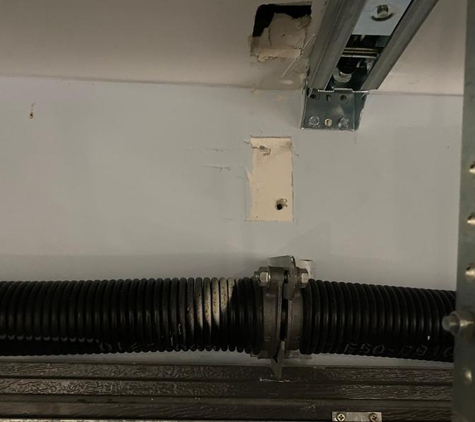 Dynamic Door Service - Clontarf, QLD. The release of the tension spring could have killed someone underneath.