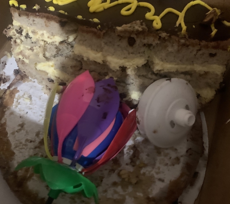 Bistro Mezzaluna Restaurant - Fort Lauderdale, FL. Leftover cake that was shoved  in the box with the broken candle that he was told to throw away