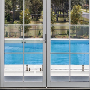 Bradnam's Windows & Doors - Bungalow, QLD. White Aluminium Hinged Door With Colonial Bars