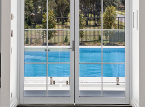 Bradnam's Windows & Doors - Carrum Downs, VIC. White Aluminium Hinged Door With Colonial Bars