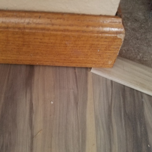 Carpet Wise Inc - Longmont, CO. Here is the raw edge sticking out from under baseboard. It shouldn't have even been set UNDER the baseboard because it caused the baseboard.