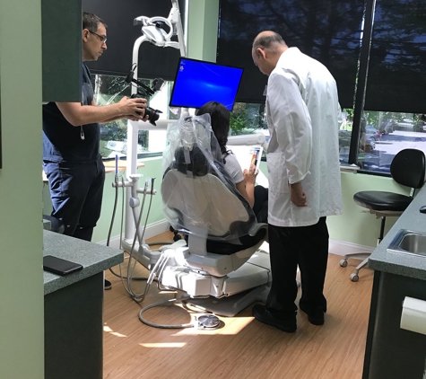 Fairfield Smiles By Design - Fairfield, CT. Dr. Pablo Cuevas explaining dental crowns options to patient at Fairfield Smiles by Design