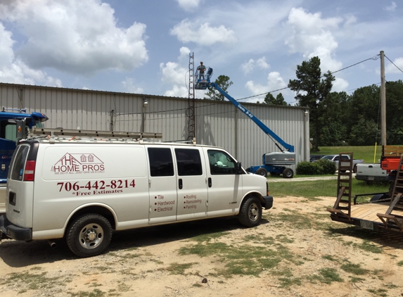 The Home Pros - Columbus, GA. Installing a metal roof on local business