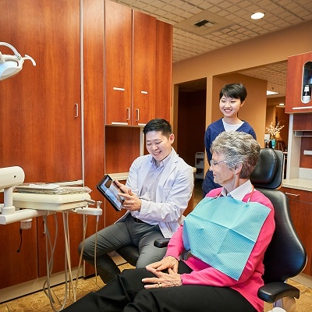 Hu Smiles in Renton - Renton, WA. Renton dentist Yuchen Hu DMD working with patient at Hu Smiles in Renton