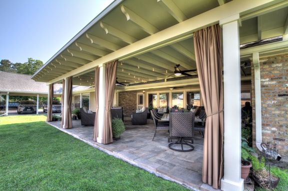 ABC Home Improvements - Baton Rouge, LA. Outside view of a covered patio with open curtains | Custom Patio Cover Arbor in Baton Rouge - www.lasunrooms.com