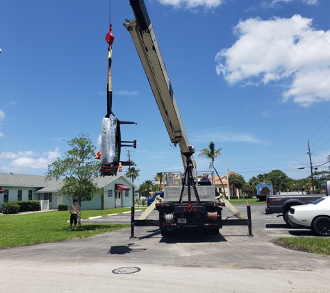Williams International - Deerfield Beach, FL. Boom Truck Crane hoisting a Grand Piano.