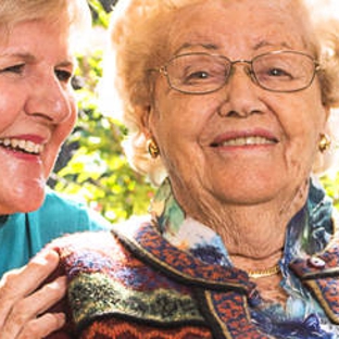 Amana Living - Spencer Park, WA. A resistent with her carer outdoors